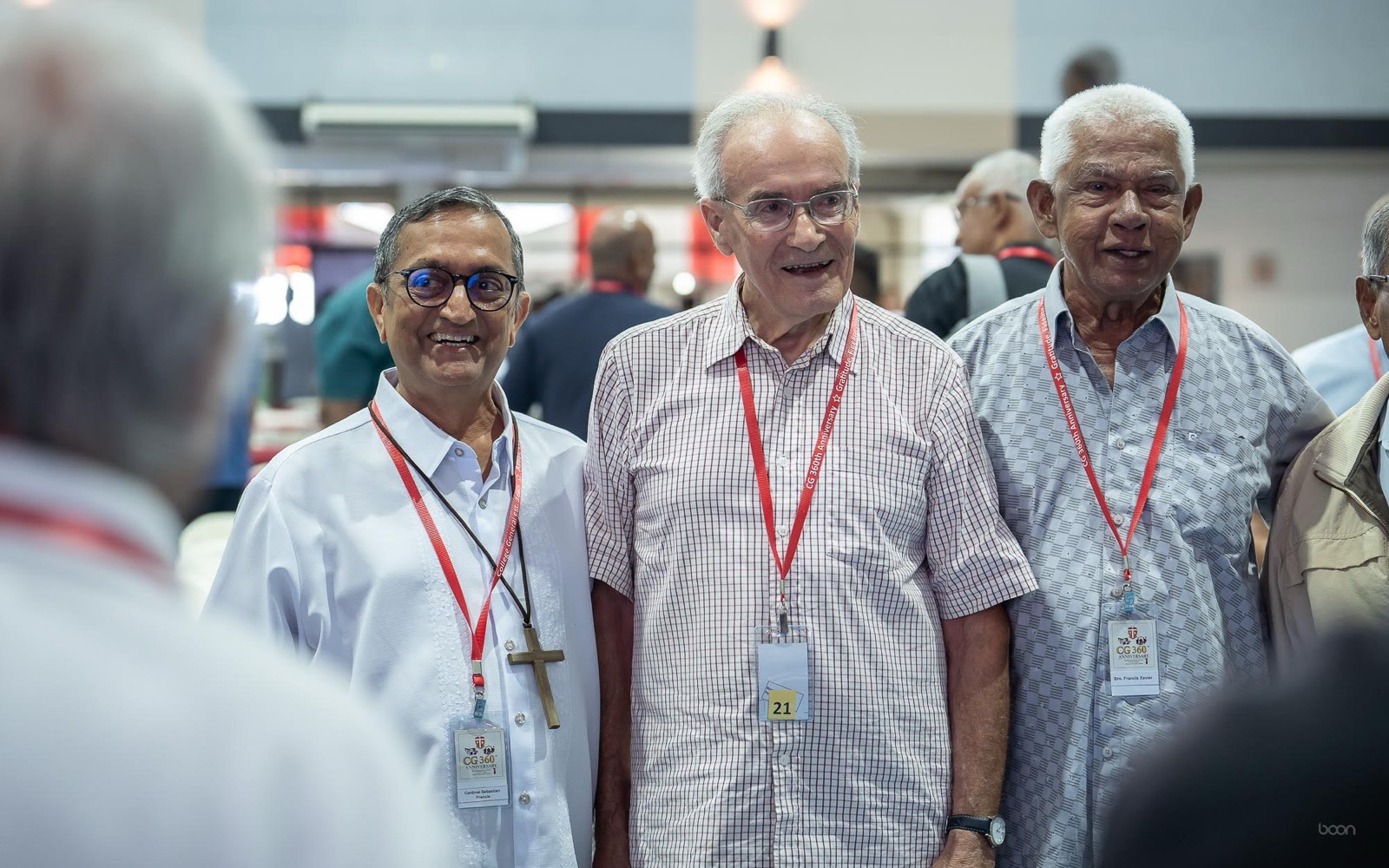 Three alumni smiling at the anniversary