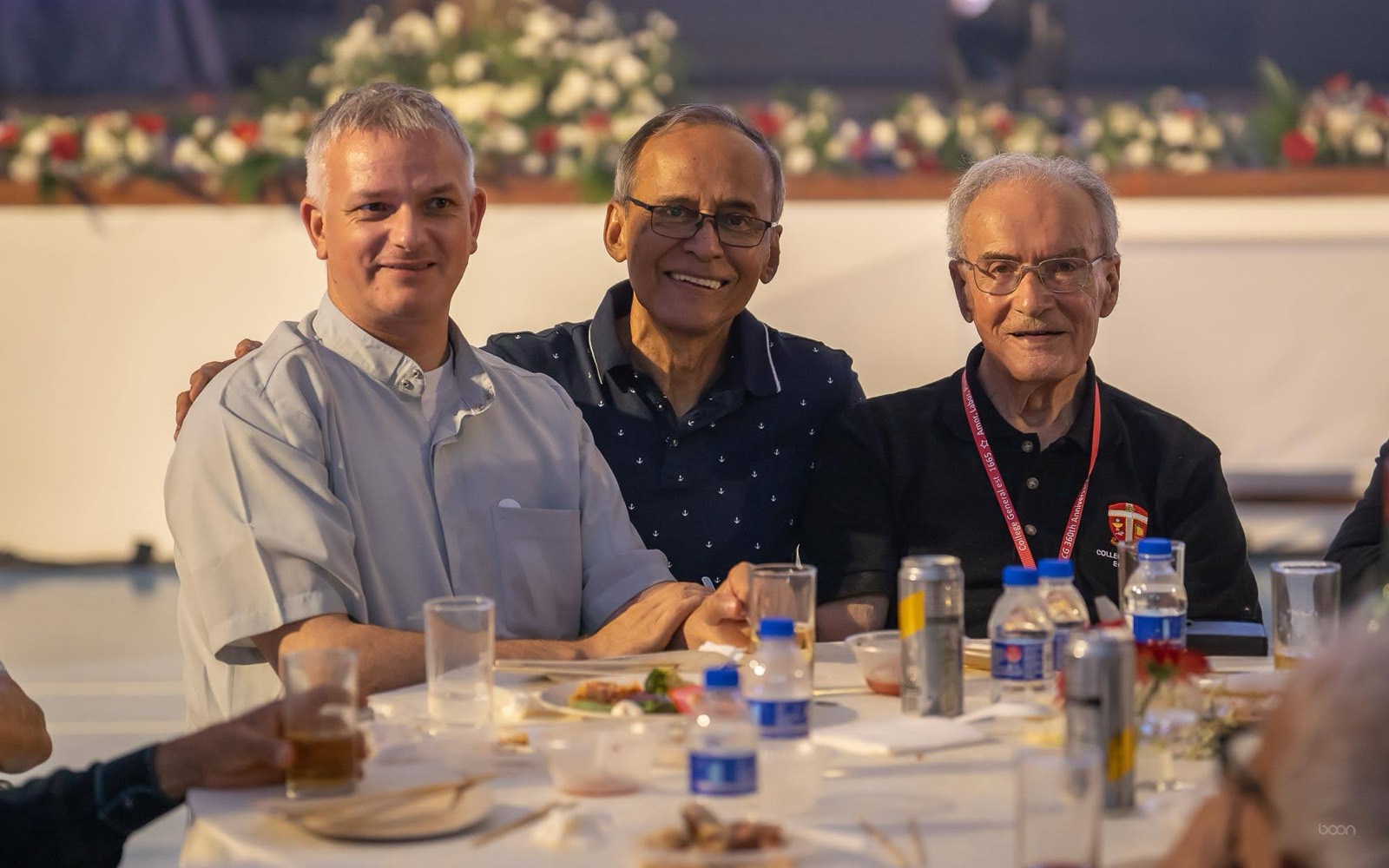 Three alumni at the anniversary dinner