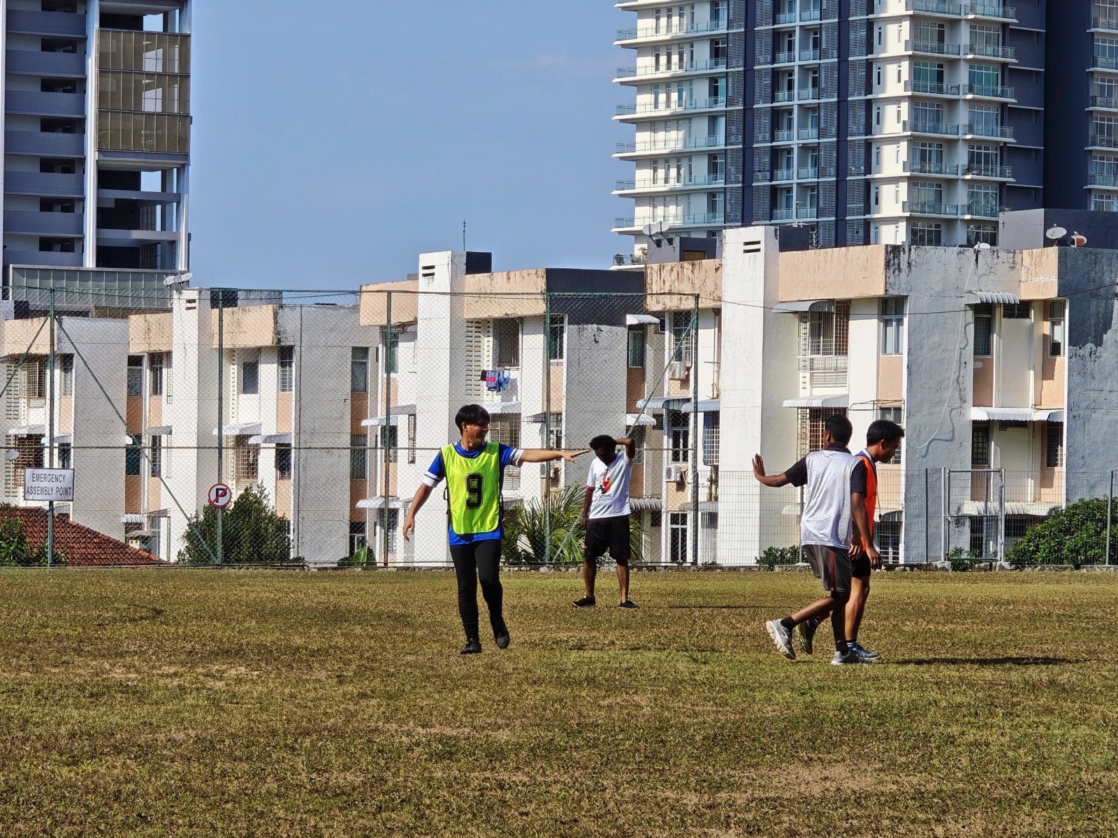 An evening game on the field below the city skyline