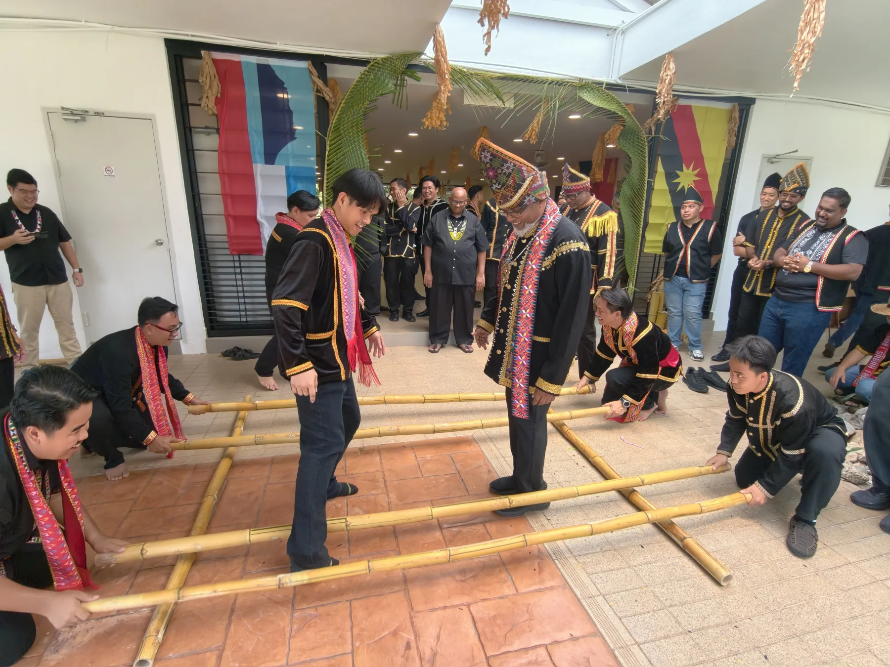 Seminarians and guests taking part in a traditional bamboo dance